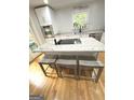 Bright eat-in kitchen features marble countertops, stainless steel appliances, and seating at 242 Adair St, Decatur, GA 30030
