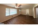 Bright living room featuring wood-look flooring, ceiling fan, and ample natural light at 570 Kenridge Cir, Stone Mountain, GA 30083