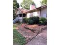 Home exterior with a covered porch, stone accents and surrounding foliage at 304 Tunis Rd, Mcdonough, GA 30253