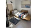 Cozy bedroom with a modern wooden bed frame, light tile, and a stylish rug at 211 Groveland Dr, Peachtree City, GA 30269