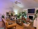 Bright living room features hardwood floors, a white brick fireplace and lovely decorations at 211 Groveland Dr, Peachtree City, GA 30269