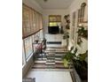 Bright sunroom featuring large windows, neutral tones, and indoor plants at 211 Groveland Dr, Peachtree City, GA 30269
