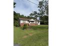 Well-maintained single-story home with classic siding and lush green lawn at 5225 Silhouette Sw Ln, Mableton, GA 30126
