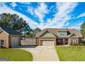 Charming home with a detached garage and a well-maintained yard, providing ample space and curb appeal at 125 Kayla Ct, Locust Grove, GA 30248