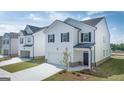 Two-story home with manicured lawn, white siding, black shutters, and a two-car garage at 11884 Aukerman Way, Hampton, GA 30228