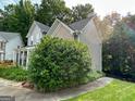 Exterior side view of house with lush green foliage and mature trees at 2355 Brick Mill Ct, Duluth, GA 30096