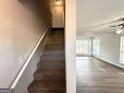 Entryway featuring stairs and updated flooring that leads into a naturally lit living space at 4320 Catalpa Way, Ellenwood, GA 30294