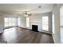 Spacious living room filled with natural light, highlighted by a classic fireplace and modern flooring at 4320 Catalpa Way, Ellenwood, GA 30294