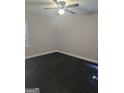 Spacious bedroom with dark wood flooring, ceiling fan, and plenty of natural light at 5425 Herndon Blvd, Morrow, GA 30260