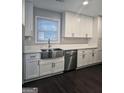 Bright kitchen with white cabinetry, quartz countertops, and stainless steel appliances at 5425 Herndon Blvd, Morrow, GA 30260