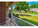 Inviting front porch view overlooking the manicured lawn and neighborhood at 1120 Bagwell Dr, Kennesaw, GA 30152