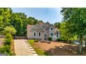 Charming home featuring a long driveway with tasteful landscaping and a classic facade at 306 Sandalin Ln, Peachtree City, GA 30269