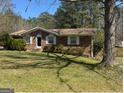 Traditional brick home with manicured lawn, showcasing timeless curb appeal and inviting entrance at 420 Dot Dr, South Fulton, GA 30349