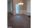 Bright dining area with carpet, a modern chandelier and plenty of natural light at 7069 Littlebrook Way, Douglasville, GA 30134
