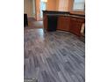 Kitchen features modern flooring, black dishwasher, and wooden cabinets at 7069 Littlebrook Way, Douglasville, GA 30134