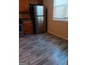 Kitchen features stainless steel refrigerator and modern flooring at 7069 Littlebrook Way, Douglasville, GA 30134
