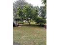 A secluded backyard with mature trees and a view of lush landscaping at 2142 E Atlanta Rd, Stockbridge, GA 30281