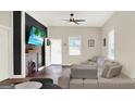Comfortable living room with a decorative fireplace, modern lighting, and ample seating at 340 Cedar St, Social Circle, GA 30025