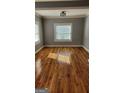 Sun-filled bedroom showcasing hardwood floors and a large window, creating a warm and inviting atmosphere at 615 Cofield Dr, Hapeville, GA 30354