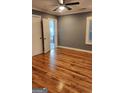 Bedroom with hardwood floors, neutral paint, and a view into the bathroom, creating a cozy space at 615 Cofield Dr, Hapeville, GA 30354