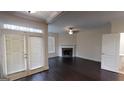 Elegant living room featuring a fireplace, hardwood floors, and access to outdoor patio at 2804 Dominion Nw Ln # Bldg 2, Kennesaw, GA 30144