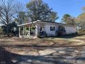 A ranch style home with a large covered front porch with lattice and plenty of space for seating at 10142 Washington Street, Covington, GA 30014