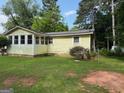 Cozy single-story home with a well-maintained lawn, bordered by lush greenery at 22 Shell Rd, Carrollton, GA 30116