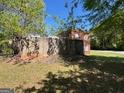 Concrete structure next to a red brick building and some trees on a sunny day at 889 W Hightower Trail, Social Circle, GA 30025