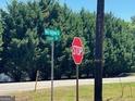 Street view with STOP and road name signs surrounded by lush greenery at 889 W Hightower Trail, Social Circle, GA 30025