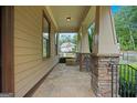 Inviting covered porch with stone pillars and a flagstone floor, perfect for relaxing and enjoying the outdoors at 3451 Fairway Dr, College Park, GA 30337