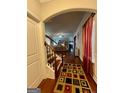 Inviting hallway with hardwood floors, decorative rug, and staircase in view at 301 Leland Ct, Mcdonough, GA 30253