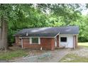 Exterior view of brick home with chain-link fence in front at 8469 Shiloh Ct, Jonesboro, GA 30238