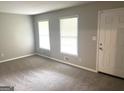 Bright living room with neutral carpet, fresh paint, and two sunny windows at 4196 Lehigh Blvd, Decatur, GA 30034