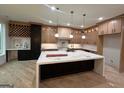 Spacious kitchen with a large island, modern appliances, custom cabinets and pendant lighting at 1293 E M Croy Rd, Sugar Hill, GA 30518