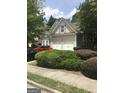 Home with a two-car garage, manicured shrubs, and a bay window on a quiet street at 1697 Preserve Park Dr, Loganville, GA 30052