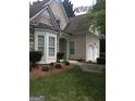 Home with a two-car garage, manicured shrubs, and a bay window on a quiet street at 1697 Preserve Park Dr, Loganville, GA 30052