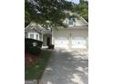 Charming home featuring a stone facade, a two-car garage, and a well-manicured lawn at 1697 Preserve Park Dr, Loganville, GA 30052