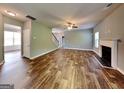 Open-concept living room featuring hardwood floors, a fireplace, and lots of natural light at 3507 Hideaway Ln, Loganville, GA 30052