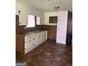 The kitchen features wood cabinets and retro flooring at 341 Boxwood St, Social Circle, GA 30025