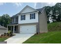 Lovely two-story home with attached two-car garage, manicured lawn, and mixed siding at 116 Deer Xing, Temple, GA 30179