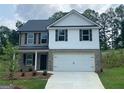 Charming two-story home with a two-car garage and a well-manicured front yard at 116 Deer Xing, Temple, GA 30179