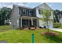 New two-story home boasting mixed siding, covered entryway, and an attached two-car garage at 116 Deer Xing, Temple, GA 30179