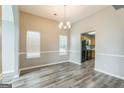 Bright dining room featuring modern floors, neutral paint, and seamless kitchen access at 2635 Carolina Rdg, Riverdale, GA 30296