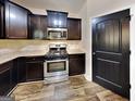 Modern kitchen with stainless steel appliances, dark cabinetry, and sleek countertops at 513 Cherry Creek Dr, Loganville, GA 30052