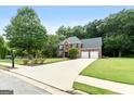 Charming two-story home with a long driveway, lush lawn and two car garage at 1028 Gloria Grand Blvd, Mcdonough, GA 30252