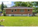 View of the spacious backyard, showing the brick home and green lawn at 1070 Elaine Dr, Forest Park, GA 30297