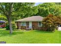 Lovely brick home featuring a well-manicured lawn and beautiful front yard landscaping at 1070 Elaine Dr, Forest Park, GA 30297
