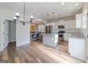 Open kitchen featuring stainless steel appliances, granite countertops, and light wood flooring at 236 Villa Grande Dr, Locust Grove, GA 30248
