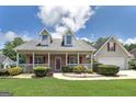 Charming single-Gathering home with a welcoming front porch and meticulously maintained landscaping at 35 Deep Springs Way, Covington, GA 30016