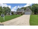 Lovely single-Gathering home showcasing a well-kept lawn and an attached two-car garage at 35 Deep Springs Way, Covington, GA 30016